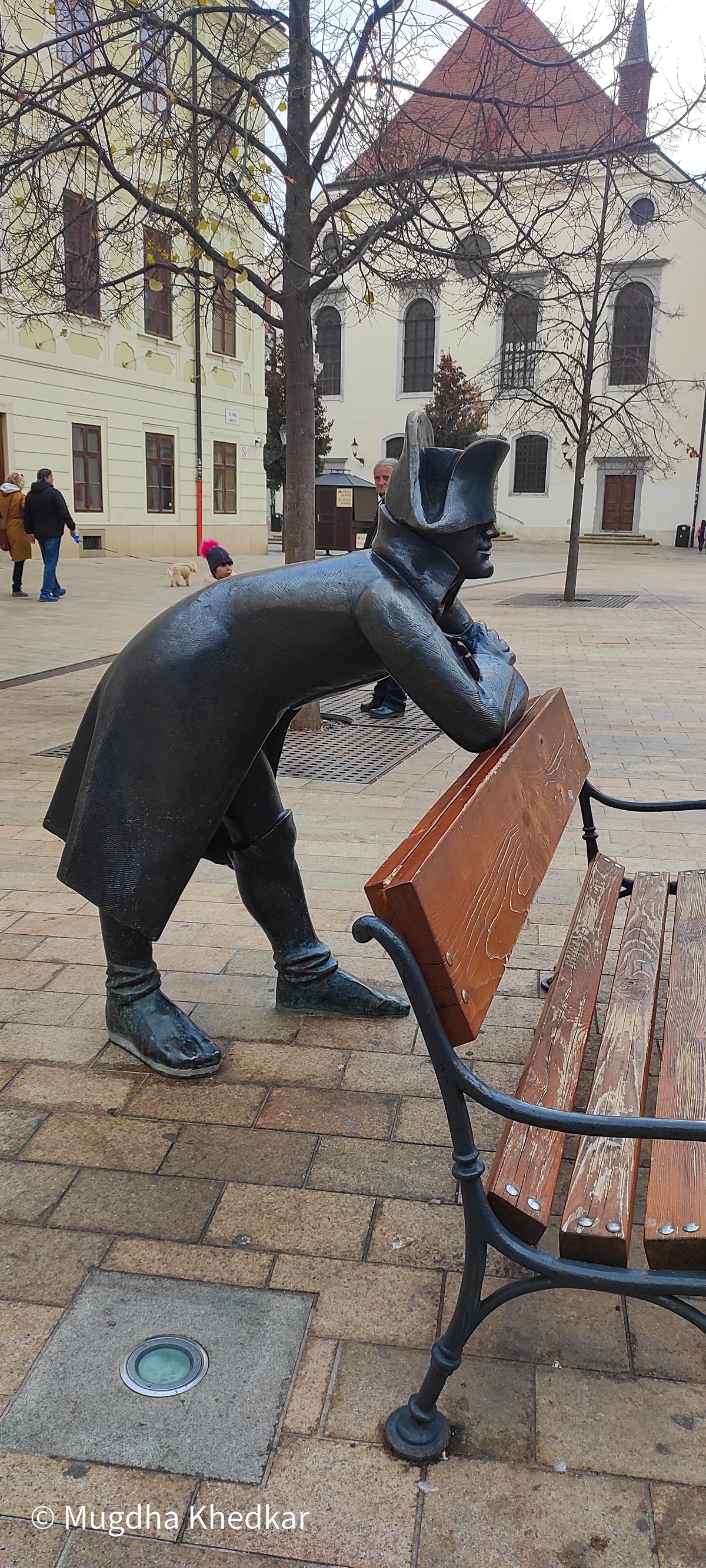 Bronze statue of a Napoleonic soldier leaning on a bench in Bratislava's Main Square