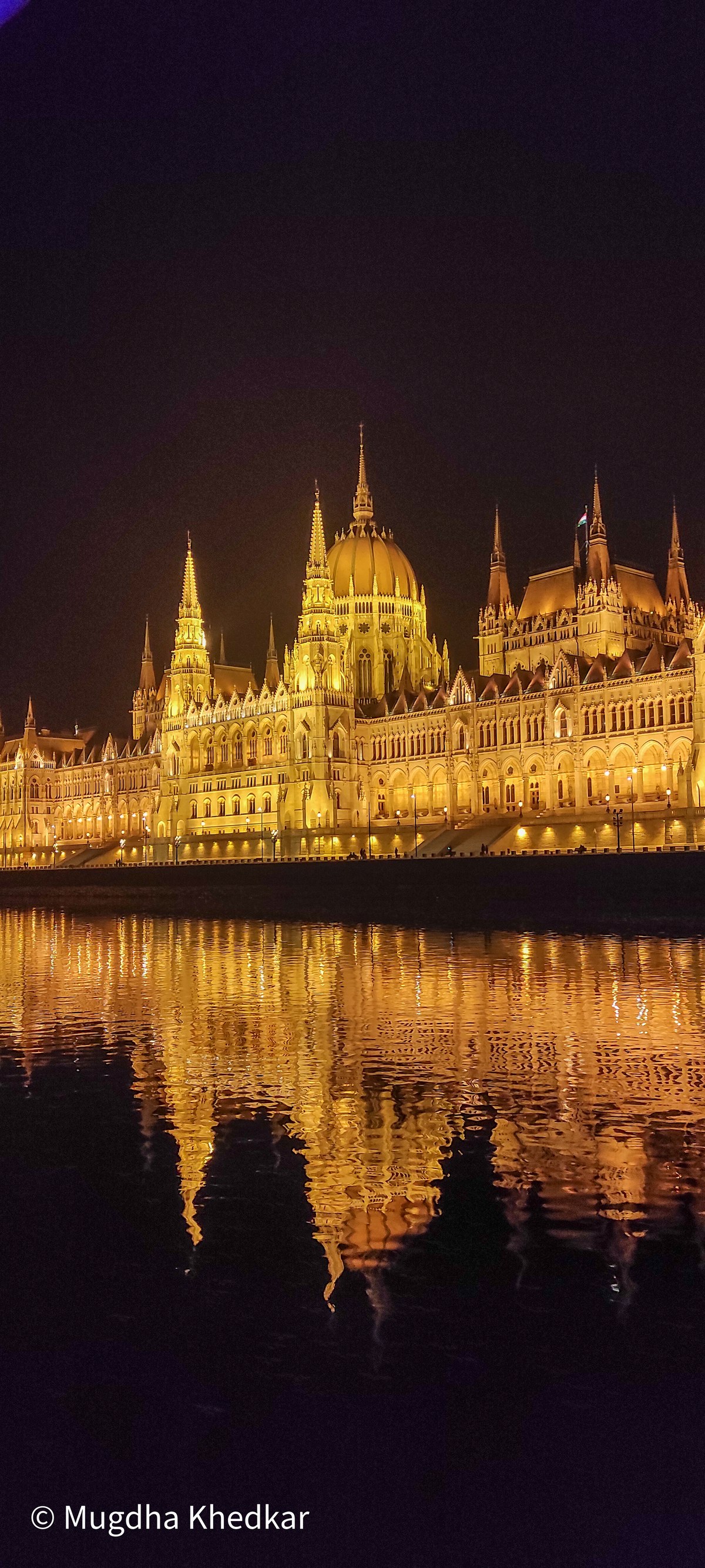 The Hungarian Parliament lit up at night and reflected in the Danube