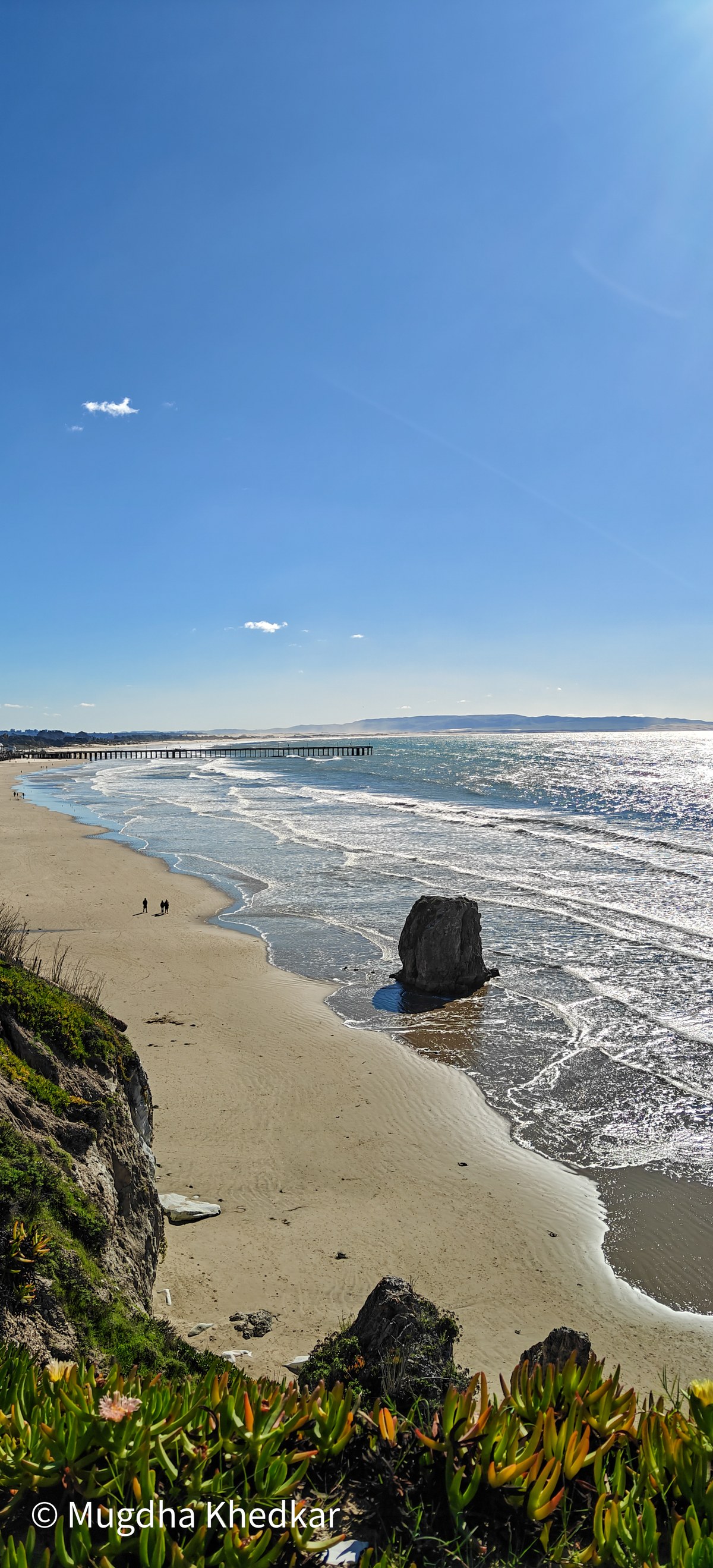 A lone sea stack on a wide sandy beach on California's Central Coast