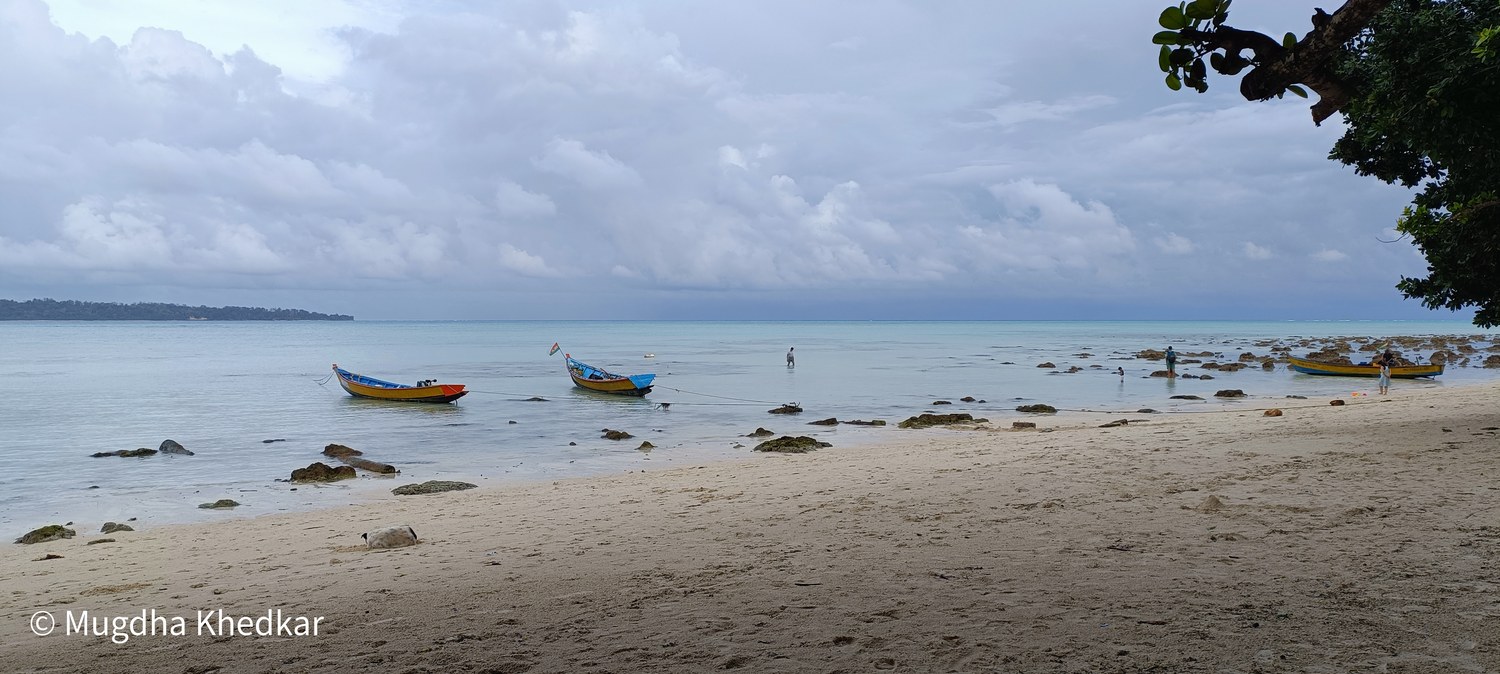 Small wooden boats off a quiet sandy beach on Havelock Island