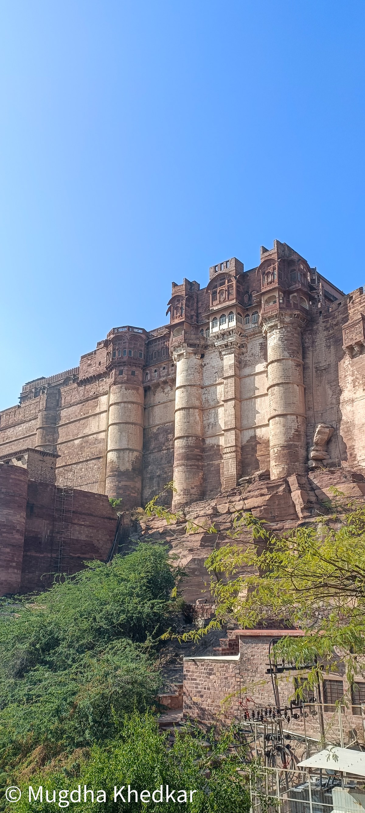 The walls of Mehrangarh Fort in Jodhpur against a blue sky