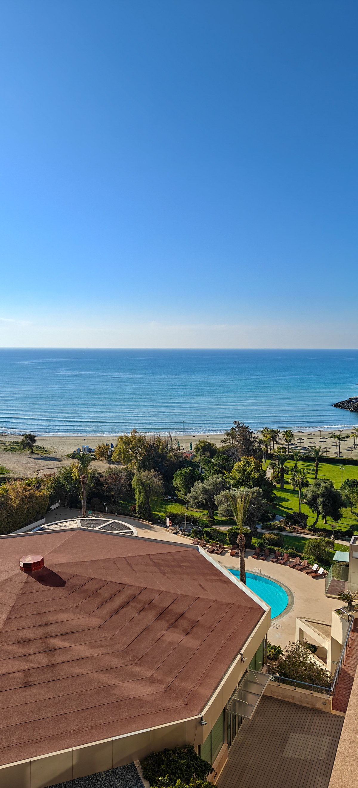 Gardens, a pool and the Mediterranean Sea seen from a hotel room in Limassol