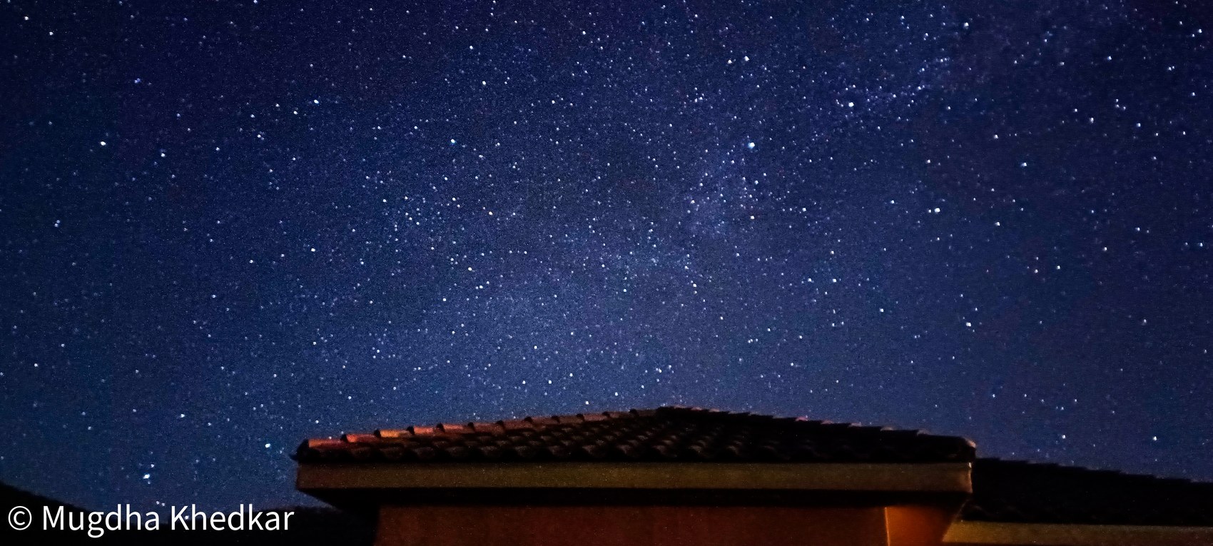 The Milky Way over a rooftop on a desert night near Joshua Tree