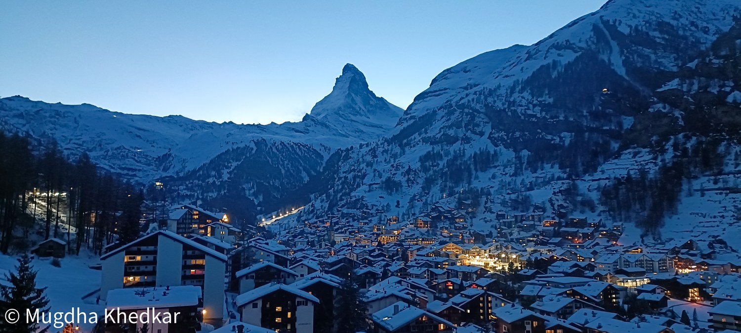 The Matterhorn above the lights of Zermatt at dusk
